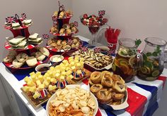 a table filled with lots of food and desserts on top of it's sides