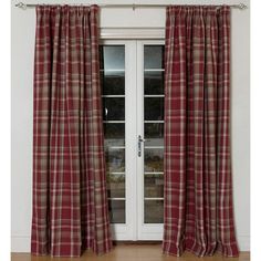 a red and tan plaid curtain hanging on a white wall in front of a door