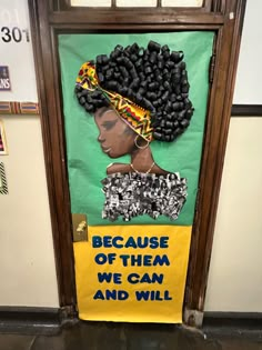 a door decorated with an african woman's head and the words because of them we can and will