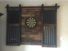 a dart board mounted to the side of a wooden wall with metal bars on it