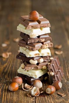 a stack of chocolate and nuts on a wooden table