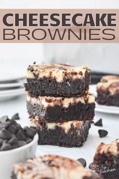 chocolate cheesecake brownies stacked on top of each other with oreo chips around them