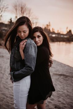 two women hugging each other on the beach