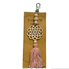 a tasseled keychain with a medallion and tassel