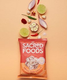 a bag of sacred foods next to sliced vegetables and limes on a pink background