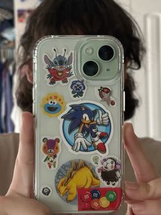 someone is holding up their phone case with stickers on it in front of the camera