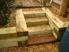 wooden steps leading up to a fenced in area