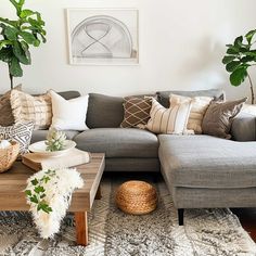 a living room filled with lots of furniture and pillows on top of a wooden table