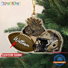 new orleans saints ornament on christmas tree with football helmet and helmet hanging from it