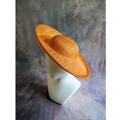 One sinamay straw hatinator base with an upturned brim in pumpkin orange that measures approximately 15" (38cm) in diameter. Crown is approximately 3" (7.6cm) high. The edges of the brim are finished in wired sinamay. The multi-layer stiffened sinamay straw has a great sturdy weave and provides excellent support for your millinery creations. Sinamay is a natural material and you will see occasional beige / brown fibers / striations in the weave. This is not a defect, but is the result of how different natural fibers respond to dye and processing. This is NOT a ready to wear finished hat and will not stay on your head unless you add a head band or elastic to wear. Add embellishments of your choice.  A nice high quality base - I know you'll be pleased! This hat base is listed separately in s Fitted Brown Boater Hat For Kentucky Derby, Orange Adjustable Wide Brim Sun Hat, Adjustable Orange Wide Brim Sun Hat, Adjustable Wide Brim Orange Sun Hat, Adjustable Brimmed Straw Hat For Church, Adjustable Short Brim Straw Hat For Church, Fitted Brimmed Straw Hat For Church, Adjustable Orange Sun Hat With Curved Brim, Fitted Brown Sun Hat For Kentucky Derby