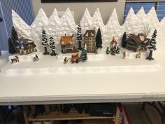 a christmas village is displayed on a table