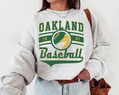 "WELCOME TO MY STORE ♥️ _This Vintage Oakland Athletic Crewneck Sweatshirt / T-Shirt, Athletics EST 1901 Sweatshirt, Oakland Baseball Game Day Shirt, Retro Athletics Shirt, Retro Oakland, Oakland Sweater, Athletics Sweater, Athletics Sweatshirt, Oakland Game Day, Athletics Fan Gift, Vintage Baseball Tee, Gift for her, Gift for Mom, Gift for him, Baseball Season, World Series, Game Day Shirt. _Please check Color and Size Charts before placing the order. You can find them in the listing's photos ( San Diego Baseball, Yankees Shirt, Steelers Sweatshirt, Broncos Sweatshirt, Boston Baseball, Dodgers Shirts, Giants Shirt, New York Vintage, Tiger Shirt