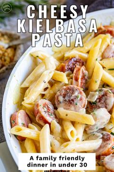 a pasta dish with sausage and tomatoes in a white bowl