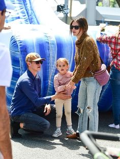 the actress and her daughter are seen with their son, who is holding his hand out to