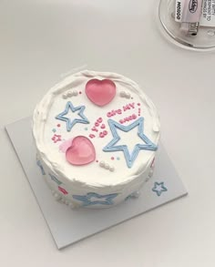 a birthday cake decorated with stars and hearts