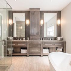 a large bathroom with two sinks and a tub