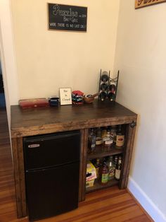 a kitchen with a refrigerator and wooden flooring