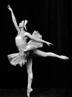 a black and white photo of a ballerina