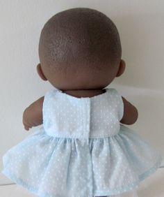 a baby doll wearing a blue and white dress