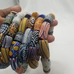 a hand holding a bunch of colorful glass beads