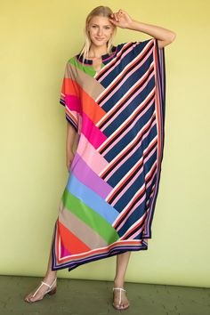 Our top-rated dress is back in a flattering, double print. Bright, rainbow color-blocking is complemented by bold stripes in the same color palette for a uniquely original look. In luxe silk, this sleek, maxi-dress caftan can be worn on its own, for a romantic dinner under the stars, or as a chic beach cover-up for your next holiday in the sun. Round, cutout neckline Relaxed, caftan fit Side slit Length: 52" Model is 5'10", wearing size XS/S FABRIC: Slim Arrow Silk Crepe de Chine 100% Silk Dry c Bold Stripes Fashion, Blouse Tile, Vacation Skirts, Printed Kaftan, Beach Blouse, Fashion Swimwear, Long Beach Dress, Patch Work, Bold Stripes