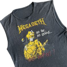 "RARE gray sleeveless Megadeth So Far, So Good...So What! tee from the 1988 album. Size Medium-Large The front features the album's artwork cover with the back reading \"so far, so good, so what!\" The graphics are perfectly faded yet clear where it matters. Luxuriously soft and light enough for summer with its breezy cotton-poly blend. No tag present. This piece is single-stitch, 50-50, made in the U.S.A. and has numerous holes throughout. See photos for best depiction of condition. Length: 23\ Vintage Sleeveless T-shirt With Graphic Print, Retro Graphic Print Sleeveless Tank Top, Grunge Sleeveless Vest For Concerts, Sleeveless Grunge Vest For Concerts, Band Merch Graphic Print Sleeveless Tank Top, Band Merch Graphic Print Tank Top, Band Merch Sleeveless Tank Top With Graphic Print, Sleeveless Band Merch Top For Streetwear, Sleeveless Band Merch Tops For Concerts