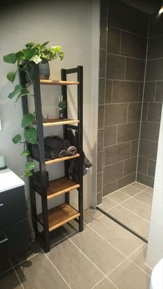 a bathroom with a shower and shelves in it