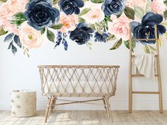 a floral wall mural with blue, pink and white flowers in the corner next to a wicker basket