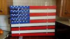 an american flag made out of strips of wood sitting on top of a kitchen counter