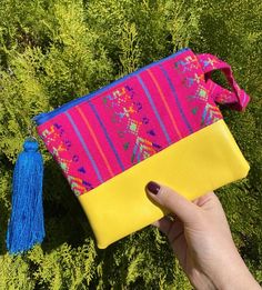 This fun and colorful cambaya bag is perfect to carry all of your essentials! Perfect for toiletries, makeup or to organize small items in your purse/backpack!These bags are handmade with Cambaya, a traditional Mexican fabric, and vinyl, a durable fabric that is easy to clean.Each one has a zipper closure and a tassel hanging from the zipper to add an extra touch of color & joy! This will make a great stocking filler or secret Santa gift!Dimensions: approximately 7.5 in x 6 in**Listing is fo Portable Multicolor Pouch Bag, Pink Handheld Pouch For Everyday Use, Handmade Pink Cosmetic Bag For Travel, Yellow Bag With Removable Pouch For Personal Use, Pink Tote-style Cosmetic Bag As Gift, Pink Tote Cosmetic Bag As A Gift, Pink Tote-shaped Cosmetic Bag For A Gift, Pink Tote Cosmetic Bag Perfect For Gifts, Multicolor Portable Travel Cosmetic Bag