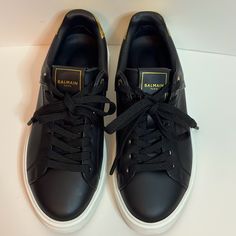 Balmain Women’s Black And Gold Sneakers. Black On The Side Of Shoes And Gold On The Back. Women’s Size 6. In Great Condition Luxury Black Low-top Sneakers, Luxury Black Lace-up Sneakers, Luxury Black Sneakers With Rubber Sole, Designer Black Low-top Sneakers, Classic Black Custom Sneakers With Studded Outsoles, Designer Black Low-top Custom Sneakers, Luxury Black Lace-up Custom Sneakers, Luxury Black Low-top Custom Sneakers, Black Custom Lace-up Sneakers With Leather Sole