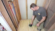 a man is working on the floor in his house