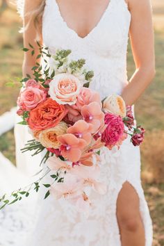 a bride holding a bouquet of flowers in her hand