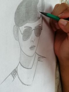 a drawing of a man wearing sunglasses and holding a green pencil in his right hand