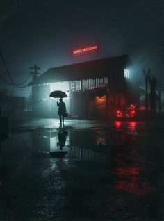 a person holding an umbrella standing in the rain at night near a bus stop on a rainy day