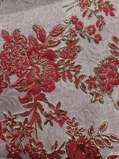 red and gold embroidered fabric with flowers on it