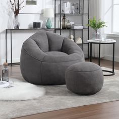 a living room scene with focus on the bean chair and ottoman