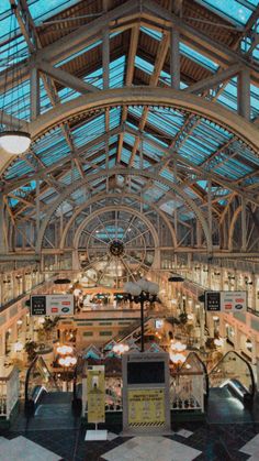 the inside of an indoor shopping mall with lots of windows and lights on it's ceiling