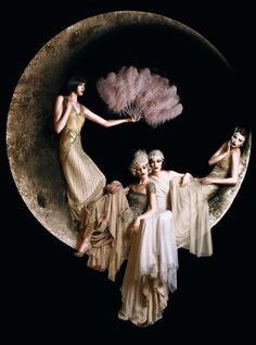 three women in dresses are sitting on the moon