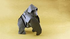 an origami elephant made out of gray paper