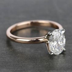 a close up view of a diamond ring on a black surface with the center stone missing