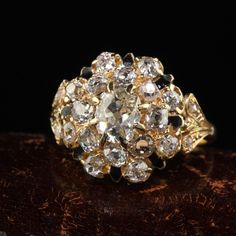 an antique diamond cluster ring sits on a table