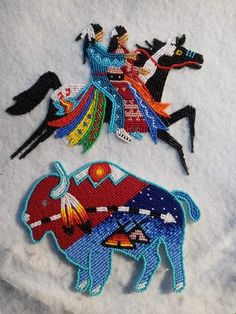 three embroidered appliques depicting native american indians riding horses and bulls on white fabric