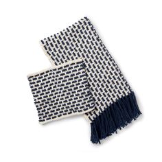 two blue and white woven scarfs on a white background, one is folded up