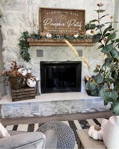 a living room filled with furniture and a fire place covered in greenery next to a fireplace