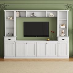 a white entertainment center with built in cabinets and a flat screen tv mounted on the wall