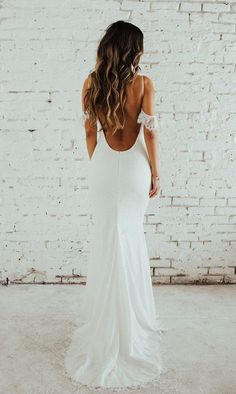 the back of a woman wearing a white wedding dress