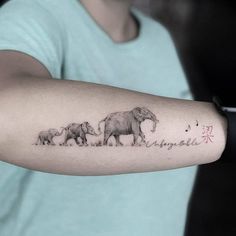 an elephant family tattoo on the arm