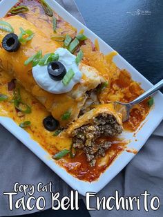 an enchilada dish with sour cream and olives