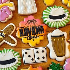 decorated cookies with the words havana on them are arranged in various shapes and colors, along with other cookie decorating items